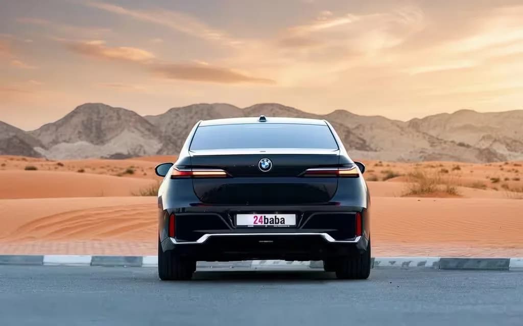 Bmw 735 2023 Black rear view showing taillights – rental in Dubai