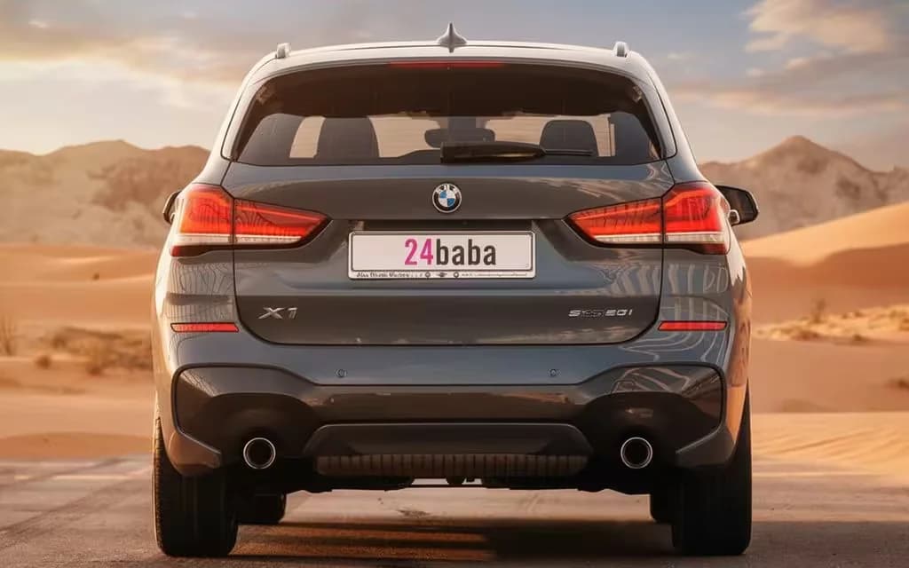 Bmw X1 2021 Blue rear view showing taillights – rental in Dubai