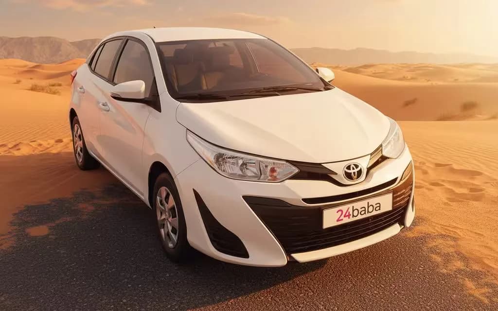 Toyota Yaris 2020 White front view with headlights – rental in Dubai