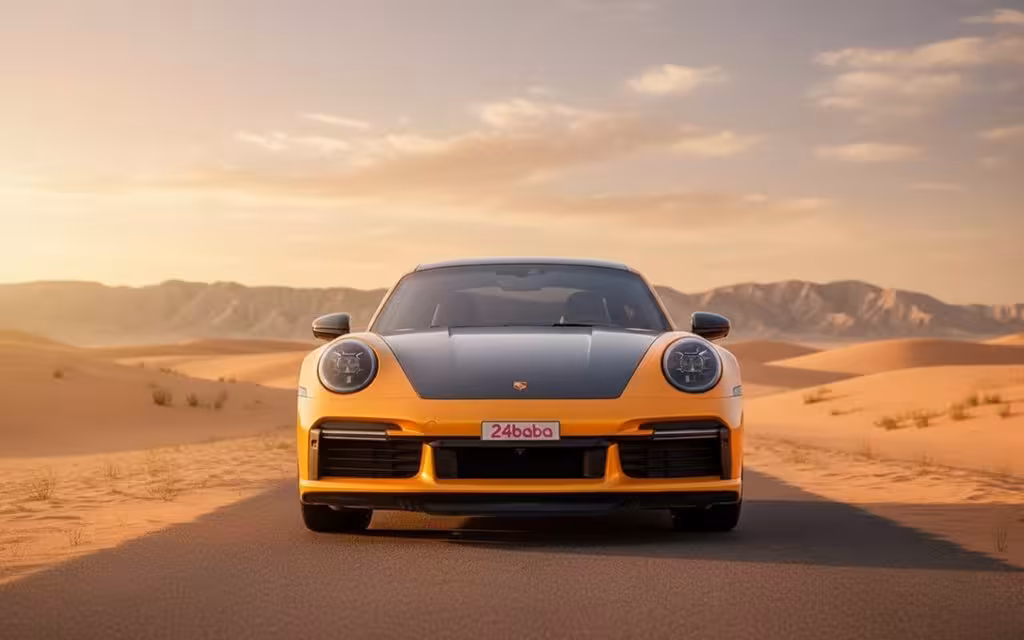 Porsche 911 2023 Orange front view with headlights – rental in Dubai