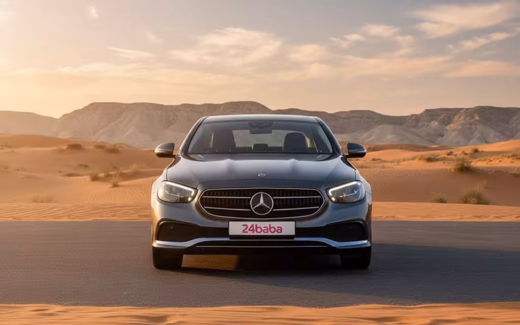 Mercedes E200 2022 Silver front view with headlights – rental in Dubai