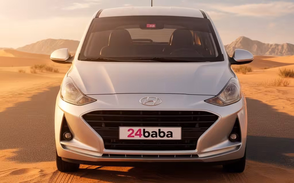 Hyundai GrandI10 2022 Silver front view with headlights – rental in Dubai
